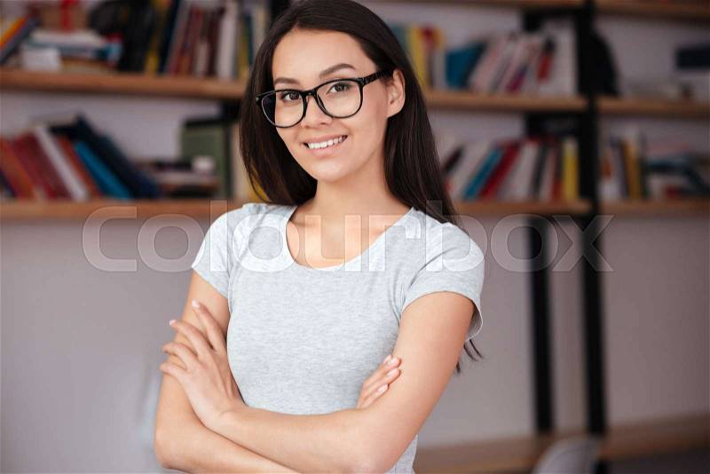 Photo of young caucasian amazing woman indoors with arms crossed. Coworking concept, stock photo