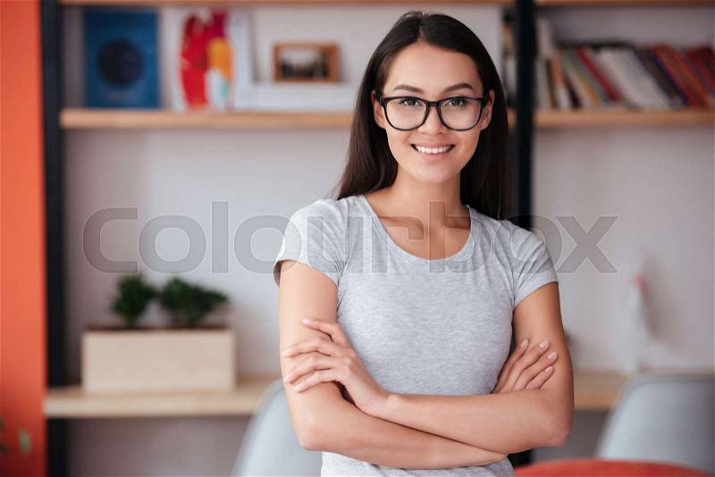 Image of young caucasian amazing woman indoors with arms crossed. Coworking concept, stock photo