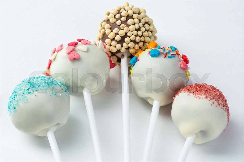 Cake pops isolated lying on white background. delicious cace pops on white table, stock photo