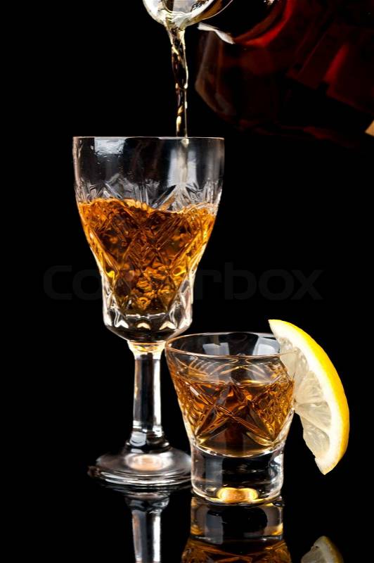 http://www.colourbox.com/preview/2506514-752342-glass-of-cognac-with-lemon-isolated-on-a-black-background.jpg