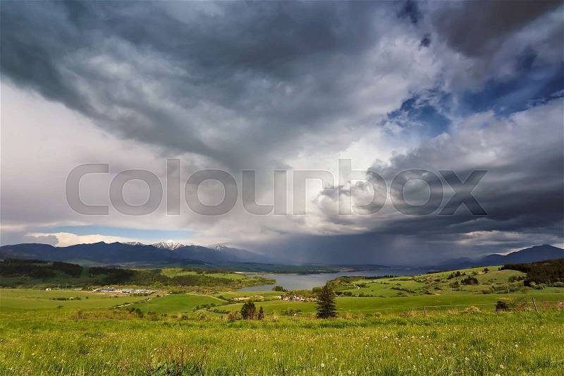 Spring rain and storm in mountains. Green spring hills of Slovakia. Spring stormy scene, stock photo