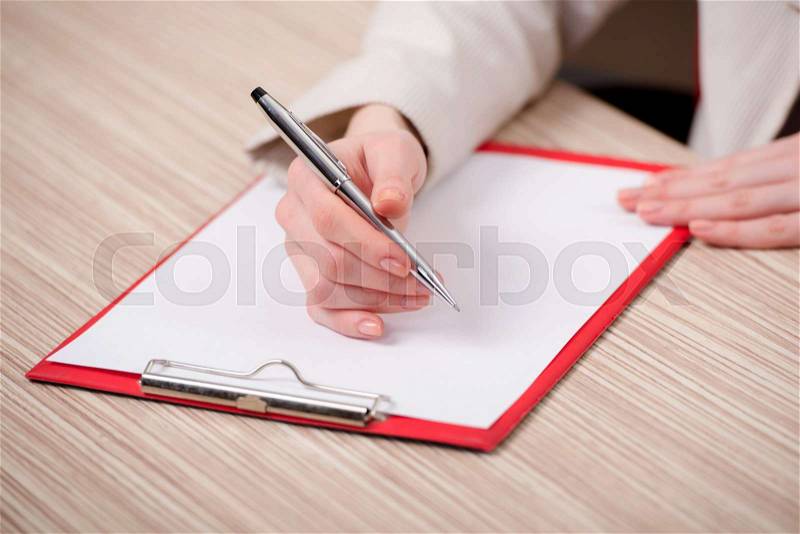 Hands taking notes in the pad, stock photo