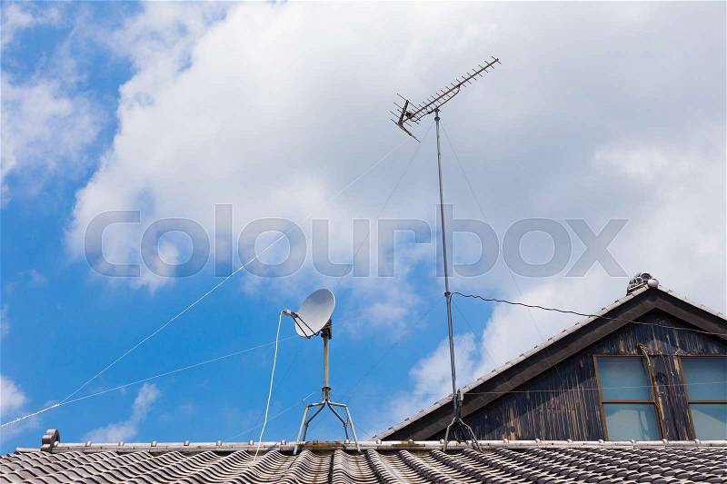 Satellite cable TV antenna on Japanese house rooftop, stock photo