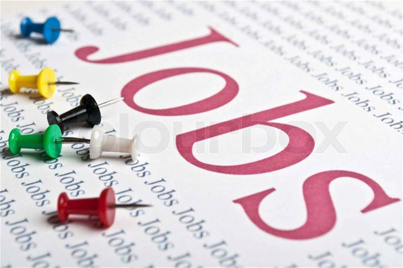 Thumbtacks stack and a sheet of paper with text on job search, stock photo
