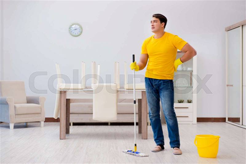Man cleaning the house helping his wife, stock photo