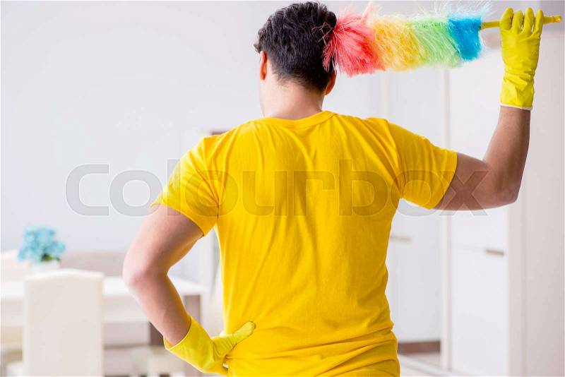Man husband cleaning the house helping his wife, stock photo