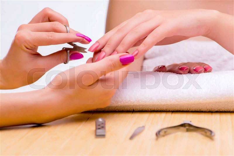 Woman hands during manicure procedure, stock photo