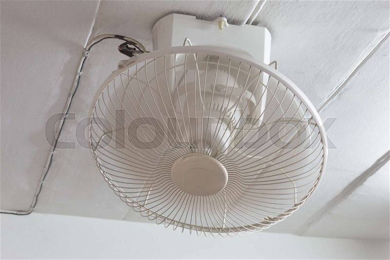 Mounted white ceiling fan being used, stock photo