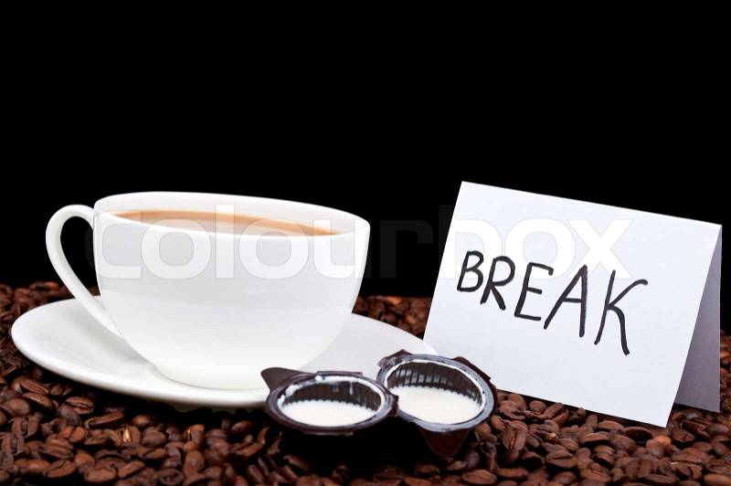 Coffee with milk and coffee beans on a black background, stock photo