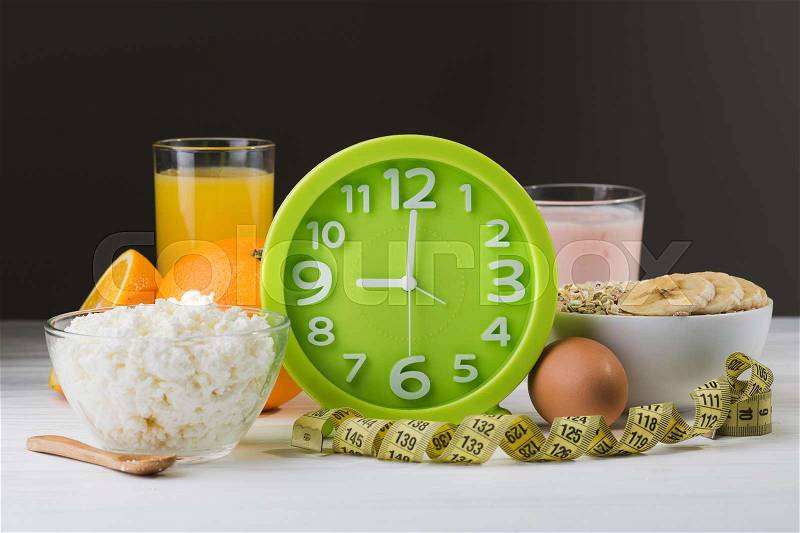 Fresh cheese, orange juice, green watch on a table. Proper and healthy breakfast food, stock photo