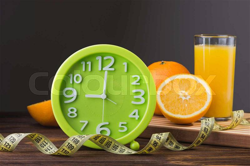 Fresh orange juice and fruits on a wood table, stock photo