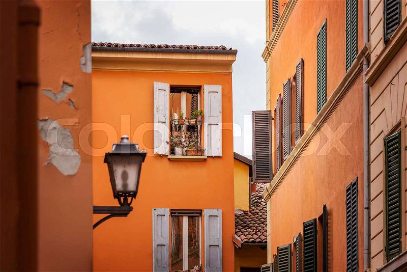 Image of street corner with brightly painted buildings in Bologna, Italy, stock photo