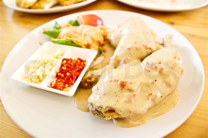 A plate of Chicken steak with sause and salad, stock photo