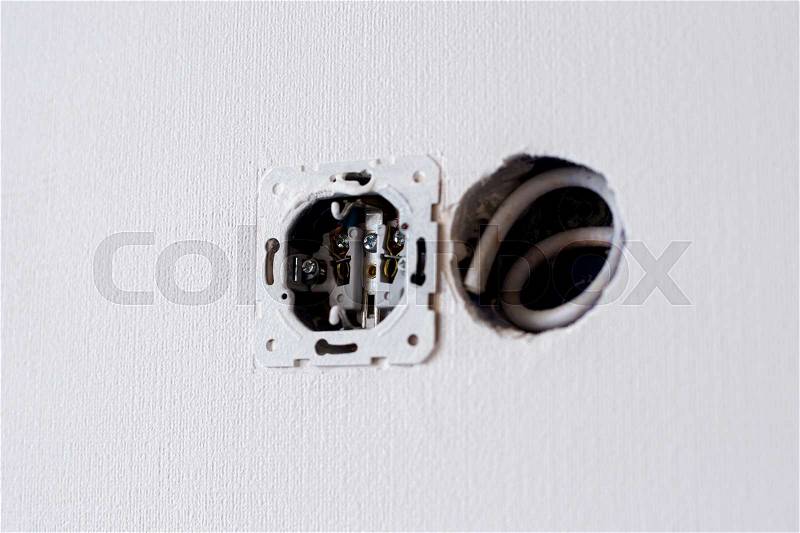 Electrical wires sticking out of the wall. Repair work, stock photo