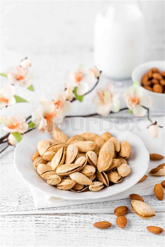 Almond nuts and milk on white background, stock photo