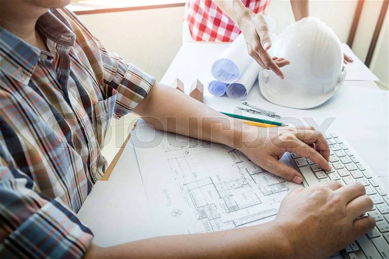 Team of architects people in group on construciton site check documents and business workflow, stock photo