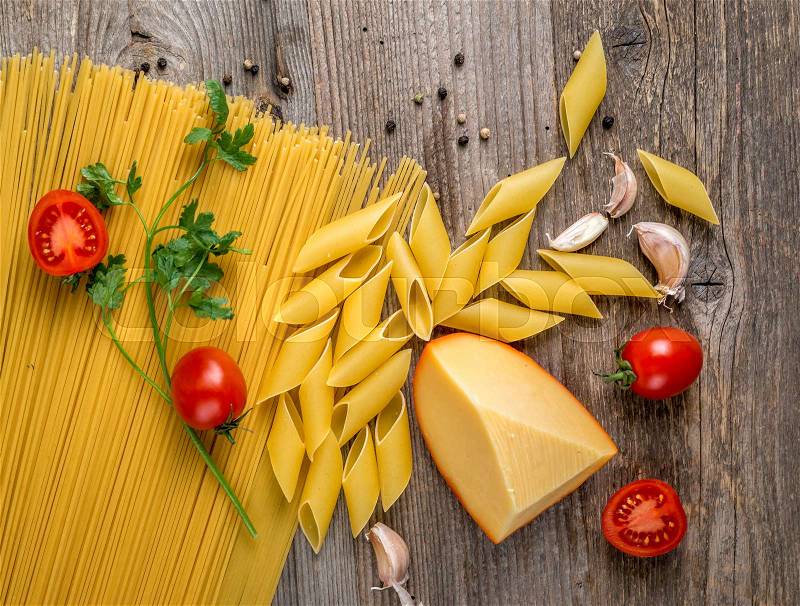 Perfect order of spaghetti, cheese and small tomatoes on the big table, topview, stock photo