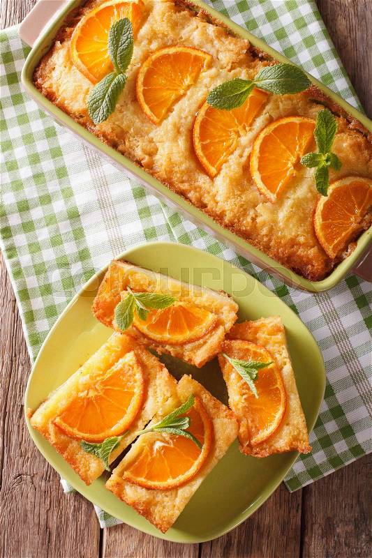 Sliced Greek Orange Pie With Phyllo - Portokalopita close-up on a table. Vertical view from above , stock photo