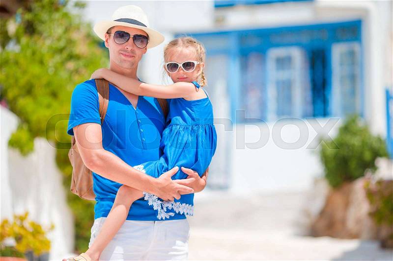 Happy dad and little adorable girl traveling in Mykonos, Greece, stock photo