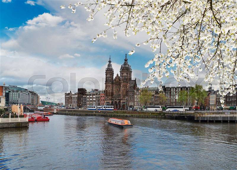 Amsterdam skyline with Church of St Nicholas over old town canal at spring, Amsterdam, Holland, stock photo