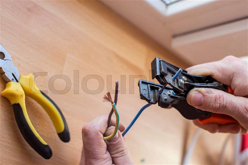 Electrician cuts the wire with special tools to connect, stock photo