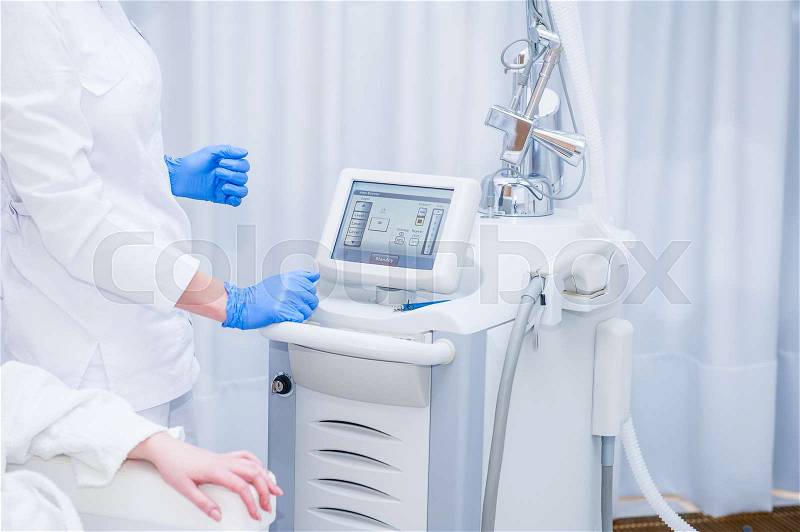Skin Treatment Laser Equipment. Medical Worker Sets Indices On Screen Of Laser for cosmetic procedures. Close up Beautician Using Beauty Machine In Cosmetology Center, Beauty Salon. Selective focus, stock photo