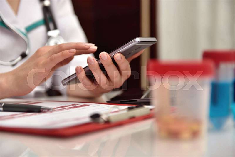 Female doctor with mobile phone. close up, stock photo