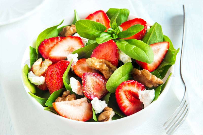 Strawberry and spinach salad with feta cheese and walnuts, organic heathy diet vegetarian salad food, stock photo