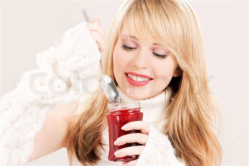 Picture of happy teenage girl with raspberry jam, stock photo