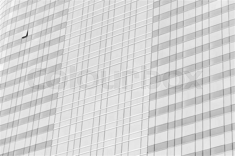 Cloud reflection in high glass offices. Blue reflection of the sky. Windows of a building. Business background in monochrome, stock photo