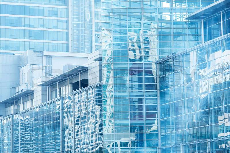 Cloud reflection in high glass offices.Blue reflection of the sky. Windows of a building. Business background, stock photo