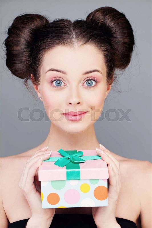 Young Woman with Gift Box. Smiling Fashion Model, stock photo