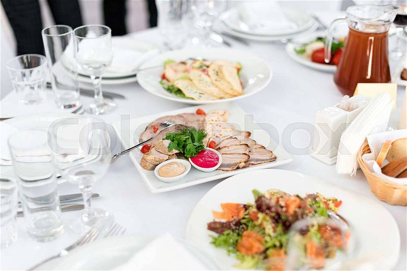 Restaurant table with food. Tasty appetizers, salads. Different meals for the guests on the wedding table, stock photo