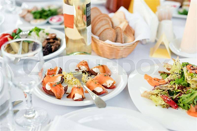 Restaurant table with food. Tasty appetizers, salads. Different meals for the guests on the wedding table, stock photo