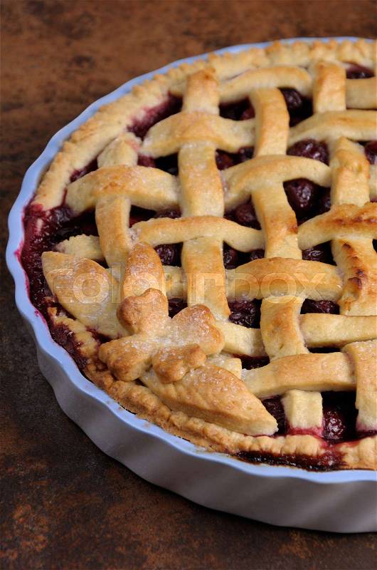 Cherry pie dough with decorative ornaments in roasting pan close-up, stock photo