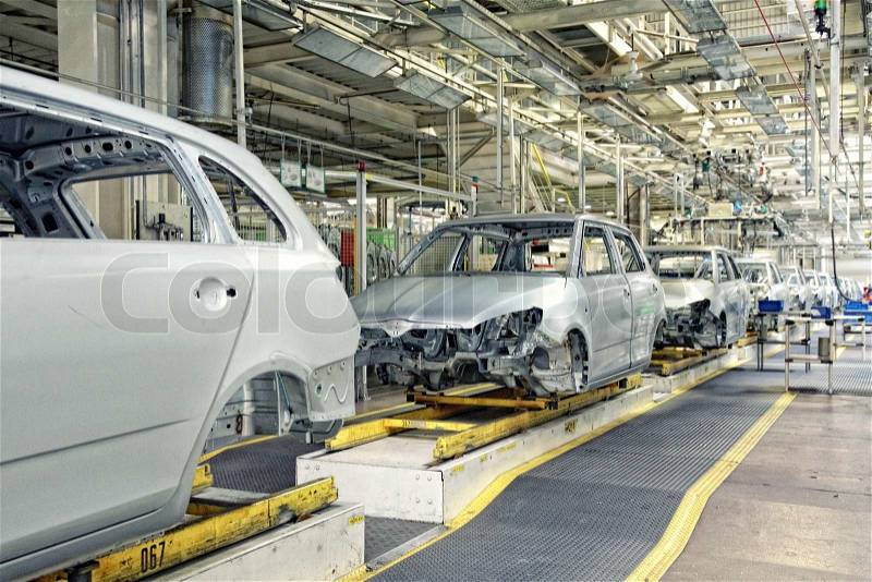 Assembled cars in a row at car plant, stock photo
