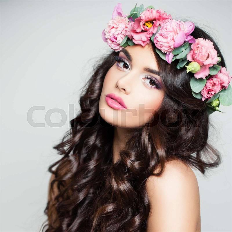 Beauty Face. Cute Woman with Curly and Flowers on Background, stock photo