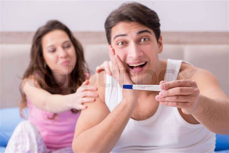 Happy couple finding out about pregnancy test results, stock photo