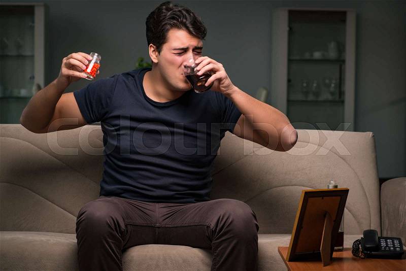 Desperate man thinking of suicide, stock photo