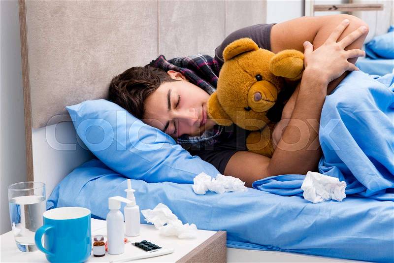 Sick ill man in the bed taking medicines and drugs, stock photo