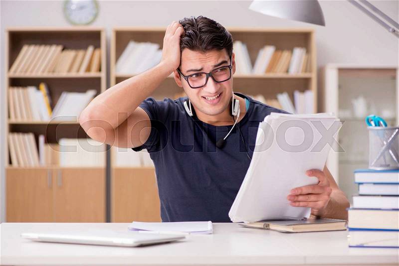 Unhappy student with too much to study, stock photo
