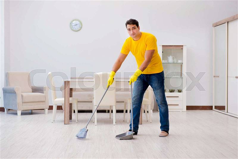 Man cleaning the house helping his wife, stock photo