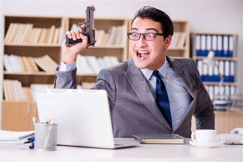 Funny businessman with gun in office, stock photo