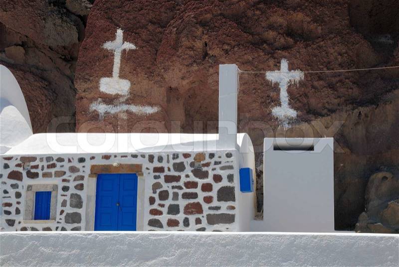 House and painted crosses on the rock, Greece, stock photo