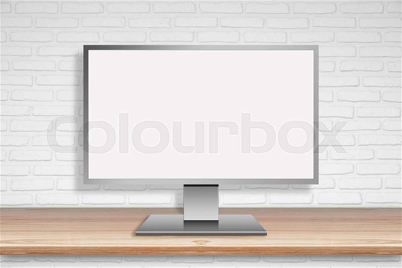 Computer Mornitor with blank screen on wood table with white wall background, stock photo