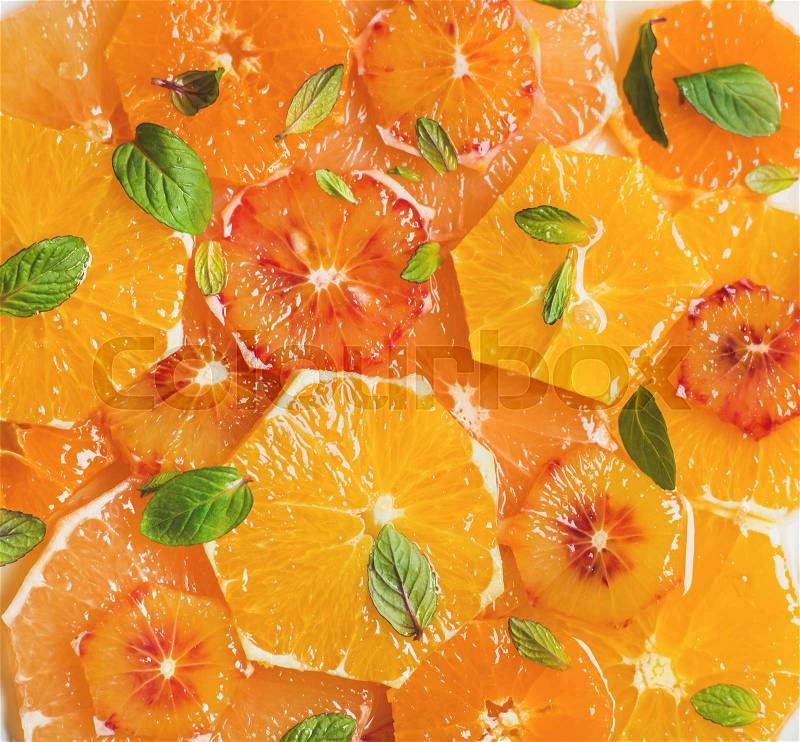 Fresh mixed citrus fruit salad with mint and honey, top view, close-up. Vegan, vegetarian, healthy, dieting, detox food, clean eating concept, stock photo