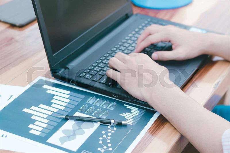 Business statistics success concept : businessman analytics financial accounting market chart and graph line with laptop computer ,selective focus. , stock photo