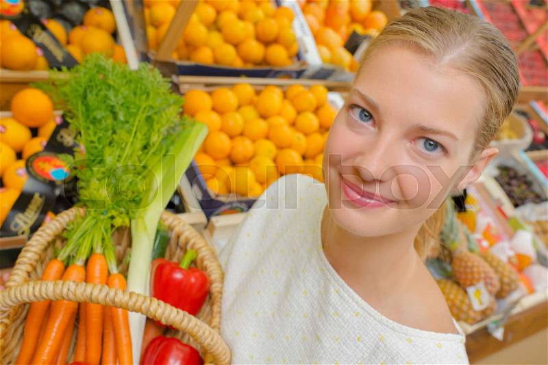 Woman buying vegetables, stock photo