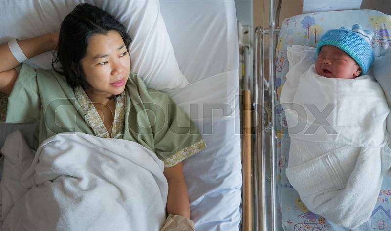 New born baby just delivery sleep with his mother in hospital, mom and baby concept, stock photo