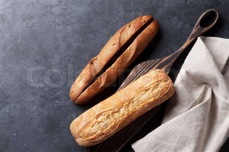 Italian ciabatta bread over stone table. Top view with copy space, stock photo